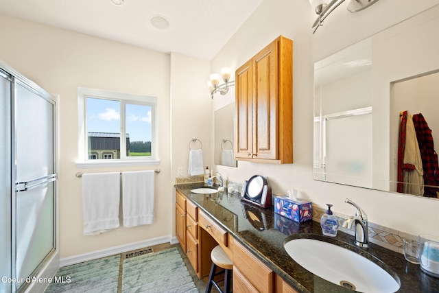 30587 S Sunray Trl, Worley, ID 83876 - full bathroom featuring an enclosed shower, double vanity, and baseboards