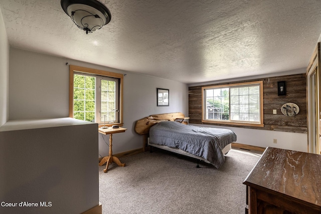 2720 Hayden Ave, Hayden, ID 83835 - bedroom featuring a textured ceiling, multiple windows, carpet floors, and baseboards