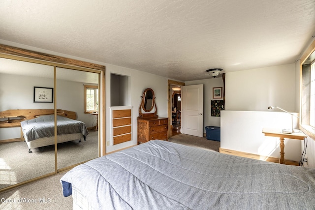 2720 Hayden Ave, Hayden, ID 83835 - bedroom featuring a closet, carpet floors, a textured ceiling, and baseboards