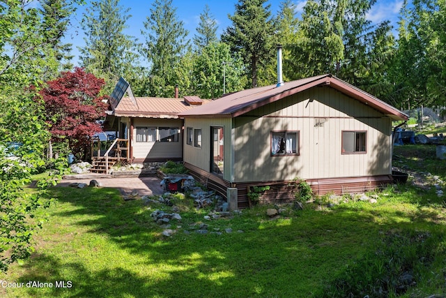 910 Otts Rd, Sagle, ID 83860 - back of property with a lawn and metal roof