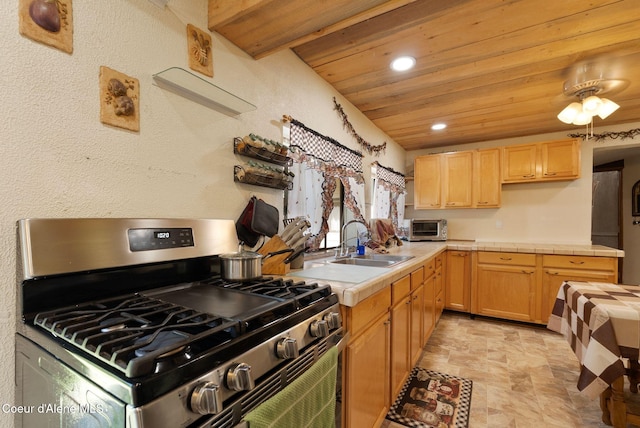 910 Otts Rd, Sagle, ID 83860 - kitchen with gas range, tile counters, a sink, wood ceiling, and stone finish flooring