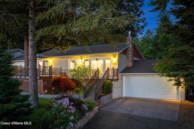 9298 N Clarkview Pl, Hayden, ID 83835 - single story home with concrete driveway, a chimney, an attached garage, and stairs