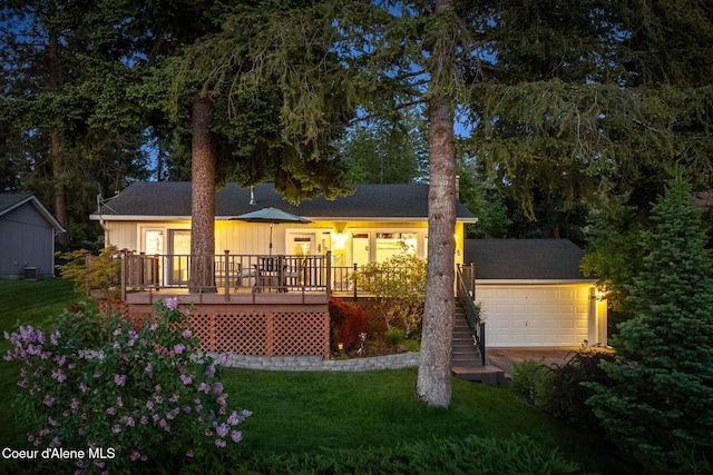 9298 N Clarkview Pl, Hayden, ID 83835 - rear view of property featuring a lawn, a deck, and a garage
