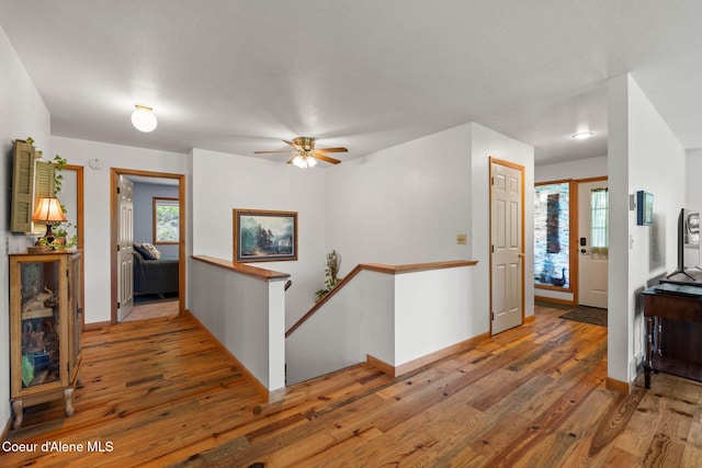 723 Trout Crk Rd, Sandpoint, ID 83864 - hallway with an upstairs landing, hardwood / wood-style flooring, and healthy amount of natural light