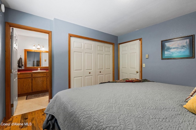 723 Trout Crk Rd, Sandpoint, ID 83864 - bedroom with wood finished floors, a closet, and ensuite bath