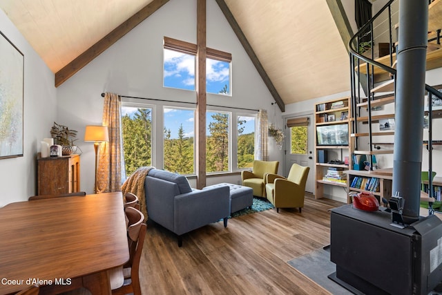 723 Trout Crk Rd, Sandpoint, ID 83864 - living room with high vaulted ceiling, wood finished floors, a wood stove, and beamed ceiling