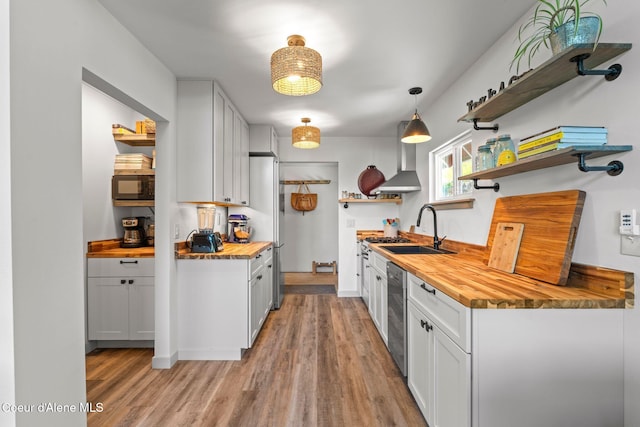 723 Trout Crk Rd, Sandpoint, ID 83864 - kitchen featuring butcher block counters, open shelves, built in microwave, and light wood finished floors