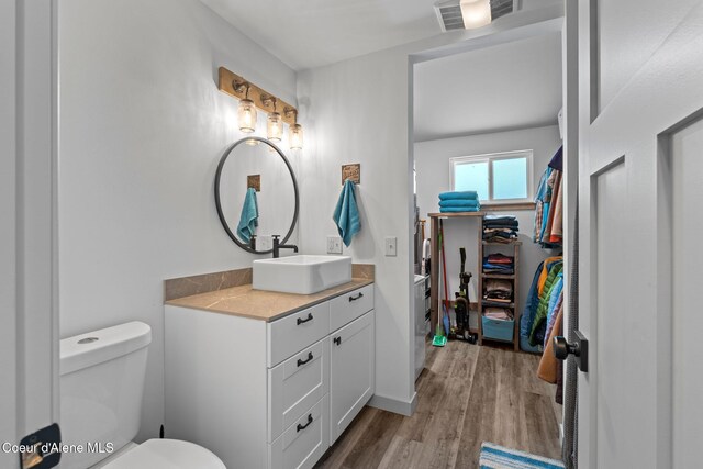 723 Trout Crk Rd, Sandpoint, ID 83864 - bathroom featuring vanity, wood finished floors, and a walk in closet