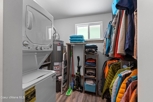 723 Trout Crk Rd, Sandpoint, ID 83864 - laundry room featuring stacked washing machine and dryer, water heater, and wood finished floors