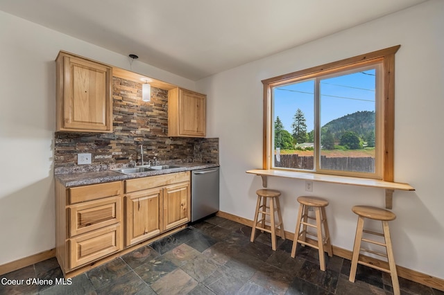 2016 N 7th St, Coeur Dalene, ID 83814 - kitchen featuring stainless steel dishwasher, a sink, baseboards, decorative backsplash, and dark countertops