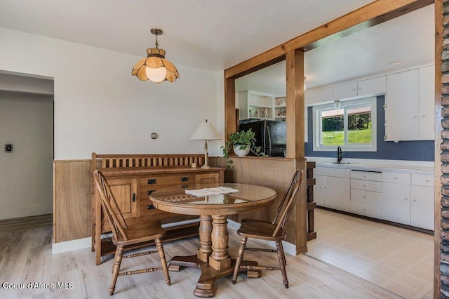 25024 N Derting Rd, Hayden, ID 83835 - dining area featuring a wainscoted wall, light wood-style flooring, breakfast area, and wooden walls