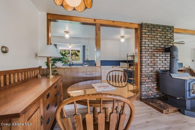 25024 N Derting Rd, Hayden, ID 83835 - dining area featuring a wood stove and light wood-style floors
