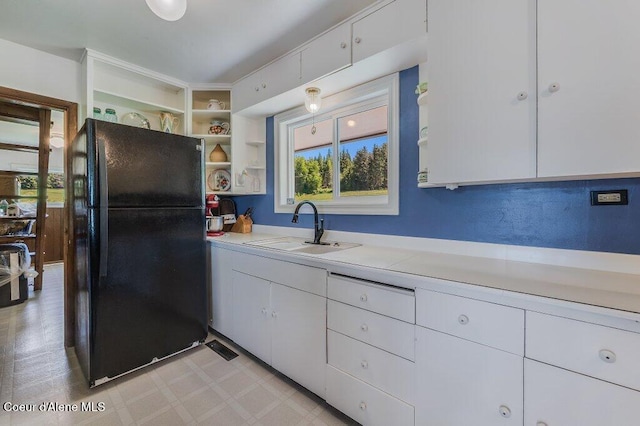 25024 N Derting Rd, Hayden, ID 83835 - kitchen featuring freestanding refrigerator, light countertops, a sink, open shelves, and white cabinetry