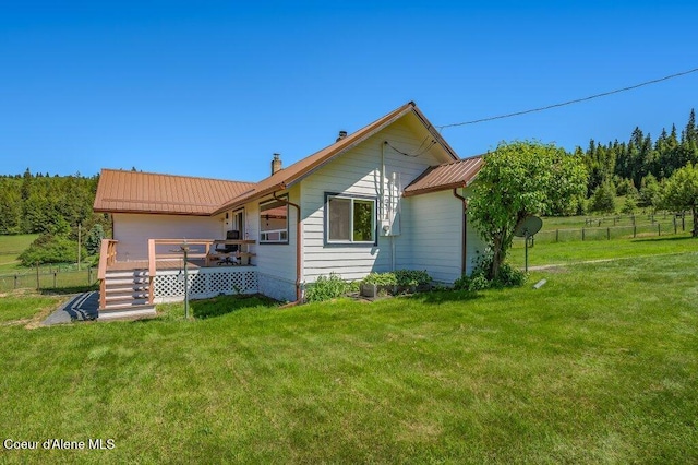 25024 N Derting Rd, Hayden, ID 83835 - rear view of property featuring a deck, metal roof, a chimney, a garage, and stairs