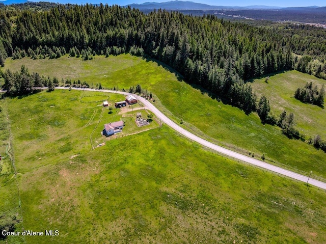 25024 N Derting Rd, Hayden, ID 83835 - bird's eye view of a heavily wooded area and a mountainous background