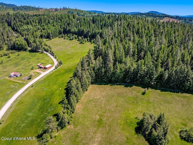 25024 N Derting Rd, Hayden, ID 83835 - bird's eye view of a heavily wooded area and a mountainous background