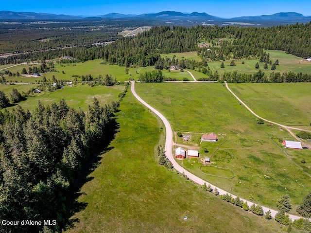 25024 N Derting Rd, Hayden, ID 83835 - view of property location featuring a mountainous background, rural landscape, and a heavily wooded area