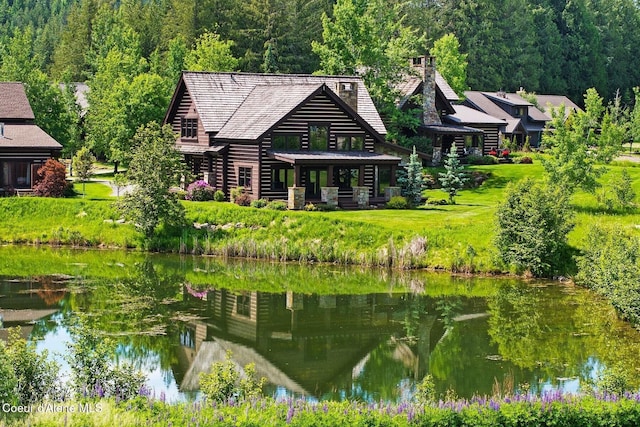 409 N Idaho Club Dr, Sandpoint, ID 83864 - back of house with log siding, a water view, and a forest view