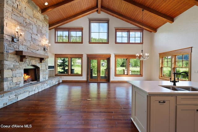 409 N Idaho Club Dr, Sandpoint, ID 83864 - kitchen with open floor plan, a sink, wooden ceiling with exposed beams, dark wood-type flooring, and light countertops