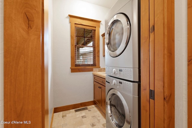 409 N Idaho Club Dr, Sandpoint, ID 83864 - washroom featuring estacked washer and dryer, cabinet space, and baseboards