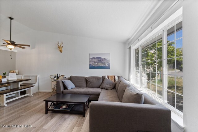 3149 N 12th St, Coeur Dalene, ID 83814 - living area featuring vaulted ceiling, light wood-style flooring, ceiling fan, and baseboards