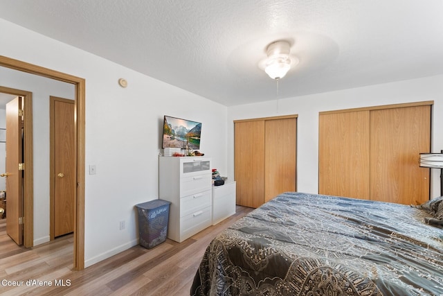3149 N 12th St, Coeur Dalene, ID 83814 - bedroom with light wood-style floors, multiple closets, and baseboards