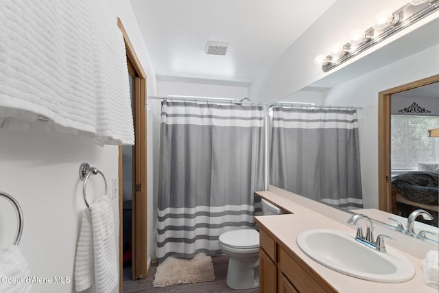 3149 N 12th St, Coeur Dalene, ID 83814 - bathroom with vanity, toilet, wood finished floors, and a shower with shower curtain