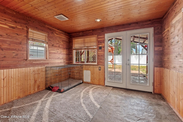 6687 W Flagstaff St, Rathdrum, ID 83858 - carpeted spare room featuring french doors, wooden walls, and wooden ceiling