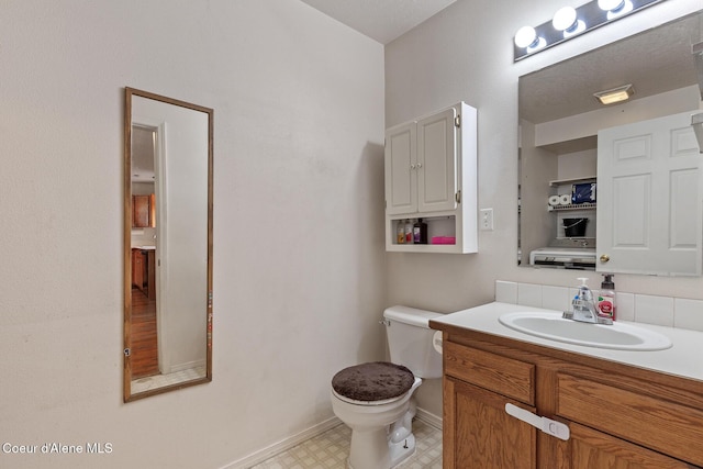 6687 W Flagstaff St, Rathdrum, ID 83858 - bathroom with toilet, vanity, baseboards, and tile patterned floors