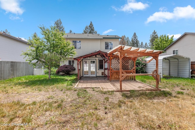 6687 W Flagstaff St, Rathdrum, ID 83858 - back of property featuring french doors, a pergola, a patio, and a detached carport