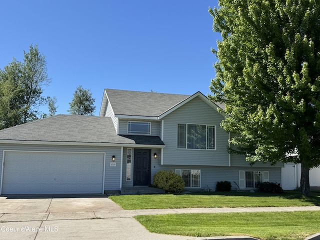8309 N Vantage Dr, Hayden, ID 83835 - tri-level home featuring an attached garage, driveway, and a front yard