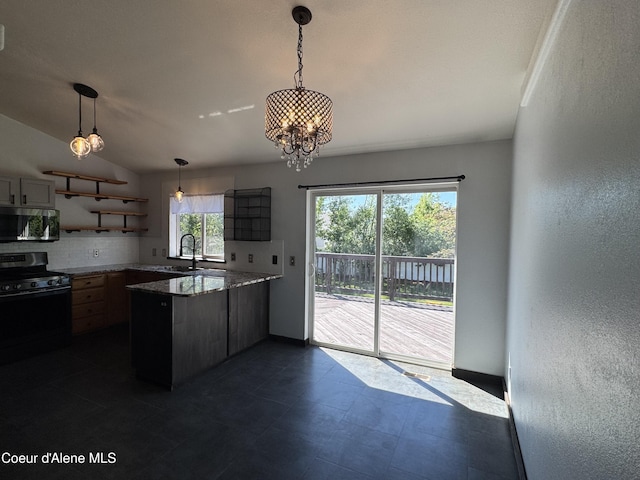 8309 N Vantage Dr, Hayden, ID 83835 - kitchen with range, stainless steel microwave, open shelves, a peninsula, and decorative backsplash