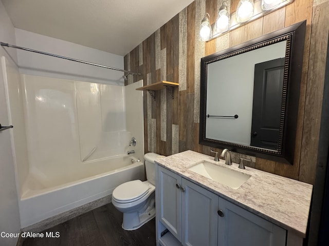 8309 N Vantage Dr, Hayden, ID 83835 - full bath with toilet, vanity, washtub / shower combination, wooden walls, and wood finished floors