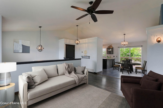 8309 N Vantage Dr, Hayden, ID 83835 - living room featuring a chandelier, dark wood-style flooring, vaulted ceiling, a ceiling fan, and baseboards