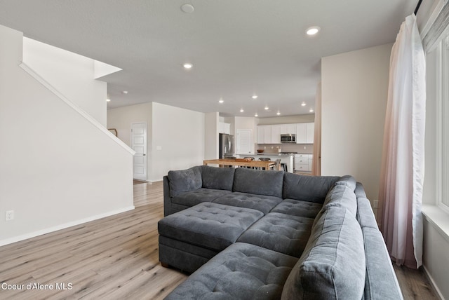 3062 N Coco St, Post Falls, ID 83854 - living area featuring light wood finished floors, baseboards, recessed lighting, and stairs