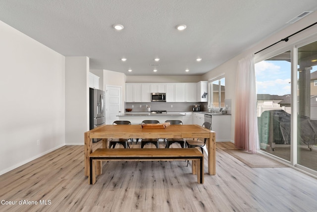 3062 N Coco St, Post Falls, ID 83854 - dining area featuring light wood finished floors, baseboards, and recessed lighting
