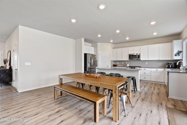 3062 N Coco St, Post Falls, ID 83854 - dining space with light wood-style flooring, recessed lighting, and baseboards
