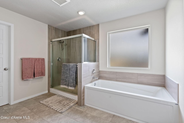 3062 N Coco St, Post Falls, ID 83854 - bathroom with a shower stall, a bath, tile patterned floors, and a textured ceiling