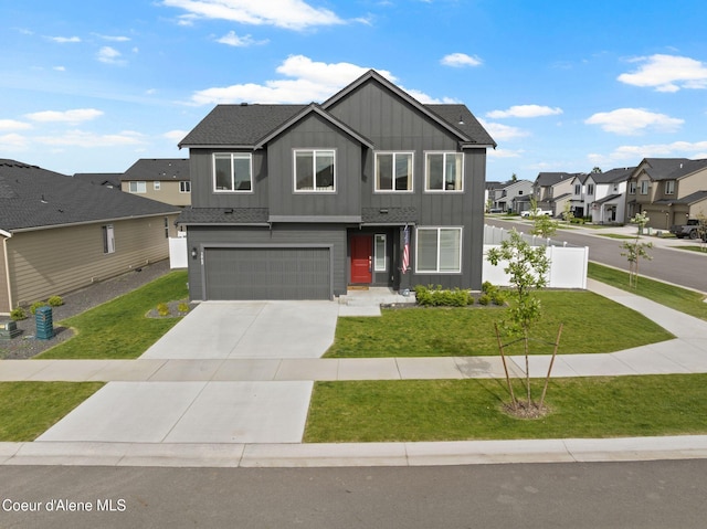 3062 N Coco St, Post Falls, ID 83854 - view of front of house with board and batten siding, a residential view, a garage, concrete driveway, and a front lawn