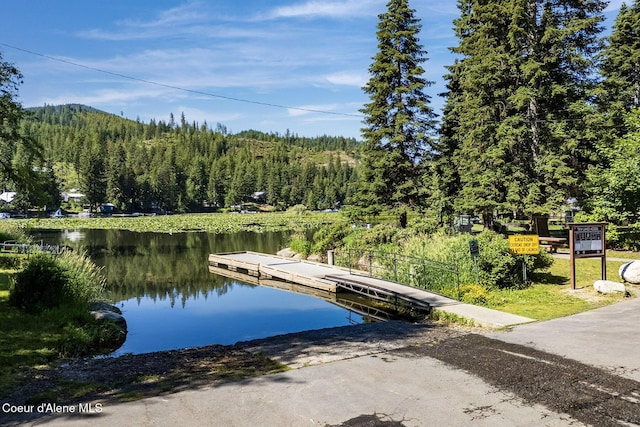 25400 N Lantern Hill Rd, Rathdrum, ID 83858 - dock area with a boat ramp, a water view, and a view of trees