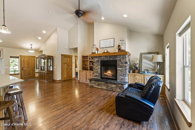 25400 N Lantern Hill Rd, Rathdrum, ID 83858 - living room featuring a stone fireplace, wood finished floors, high vaulted ceiling, a ceiling fan, and recessed lighting