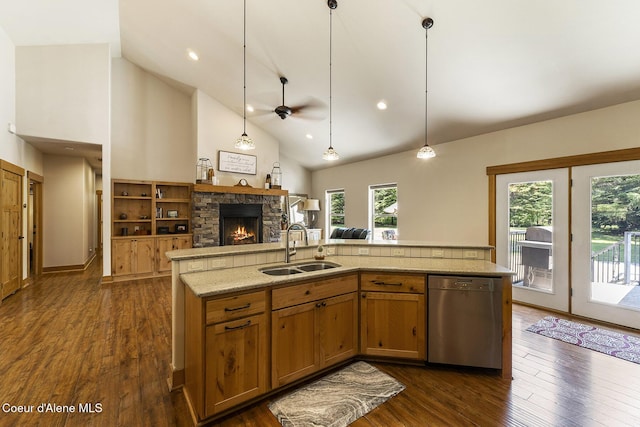 25400 N Lantern Hill Rd, Rathdrum, ID 83858 - kitchen with stainless steel dishwasher, a stone fireplace, ceiling fan, open floor plan, and hanging light fixtures