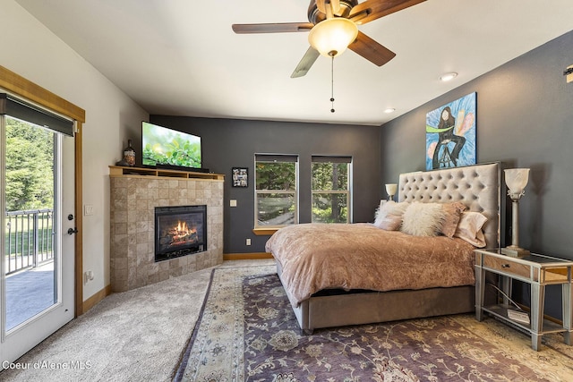 25400 N Lantern Hill Rd, Rathdrum, ID 83858 - bedroom with carpet floors, access to exterior, multiple windows, and a fireplace
