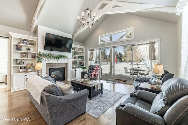 10383 N Morris Rd, Hayden Lake, ID 83835 - living room featuring high vaulted ceiling, a fireplace, beamed ceiling, light wood finished floors, and a chandelier