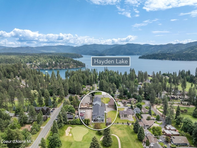 10383 N Morris Rd, Hayden Lake, ID 83835 - aerial view of property and surrounding area with a water and mountain view, property parcel outlined, and a forest
