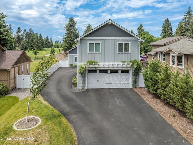 10383 N Morris Rd, Hayden Lake, ID 83835 - view of front of home with board and batten siding, driveway, and a garage