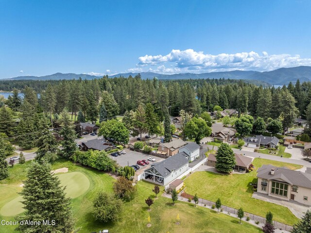 10383 N Morris Rd, Hayden Lake, ID 83835 - aerial perspective of suburban area featuring a forest, mountains, and a local golf course