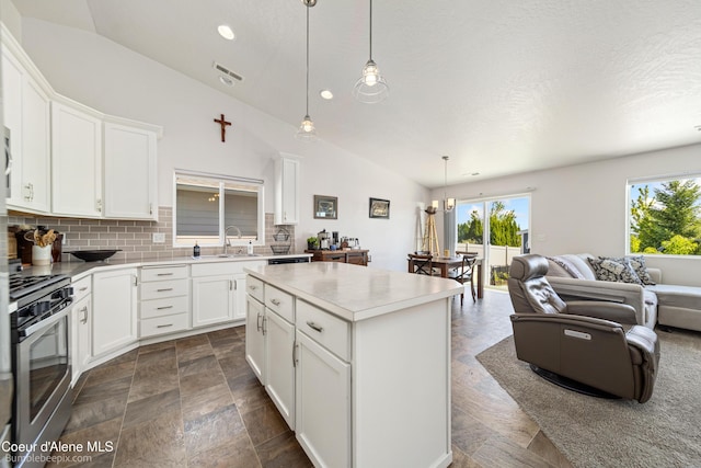 4281 N Shelburne Loop, Post Falls, ID 83854 - kitchen featuring gas stove, vaulted ceiling, a sink, plenty of natural light, and open floor plan