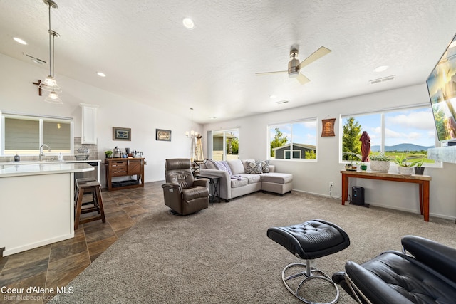 4281 N Shelburne Loop, Post Falls, ID 83854 - living area featuring ceiling fan, recessed lighting, a textured ceiling, dark stone finish flooring, and lofted ceiling