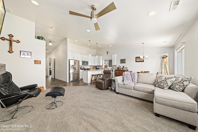 4281 N Shelburne Loop, Post Falls, ID 83854 - living room featuring recessed lighting, a ceiling fan, a chandelier, and dark carpet